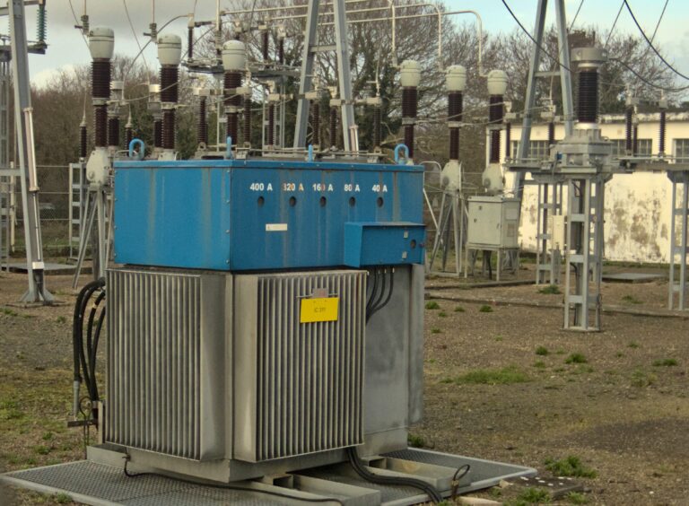 High-voltage substation, photo by PtiBzh via Wikimedia Commons